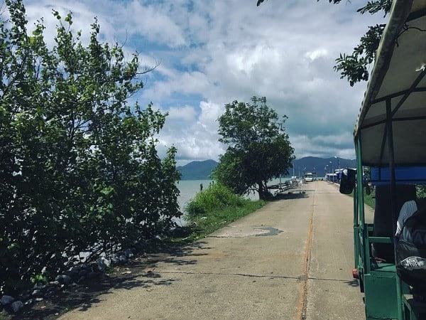 The shuttle mini bus will stop before the 'Stop' signboard